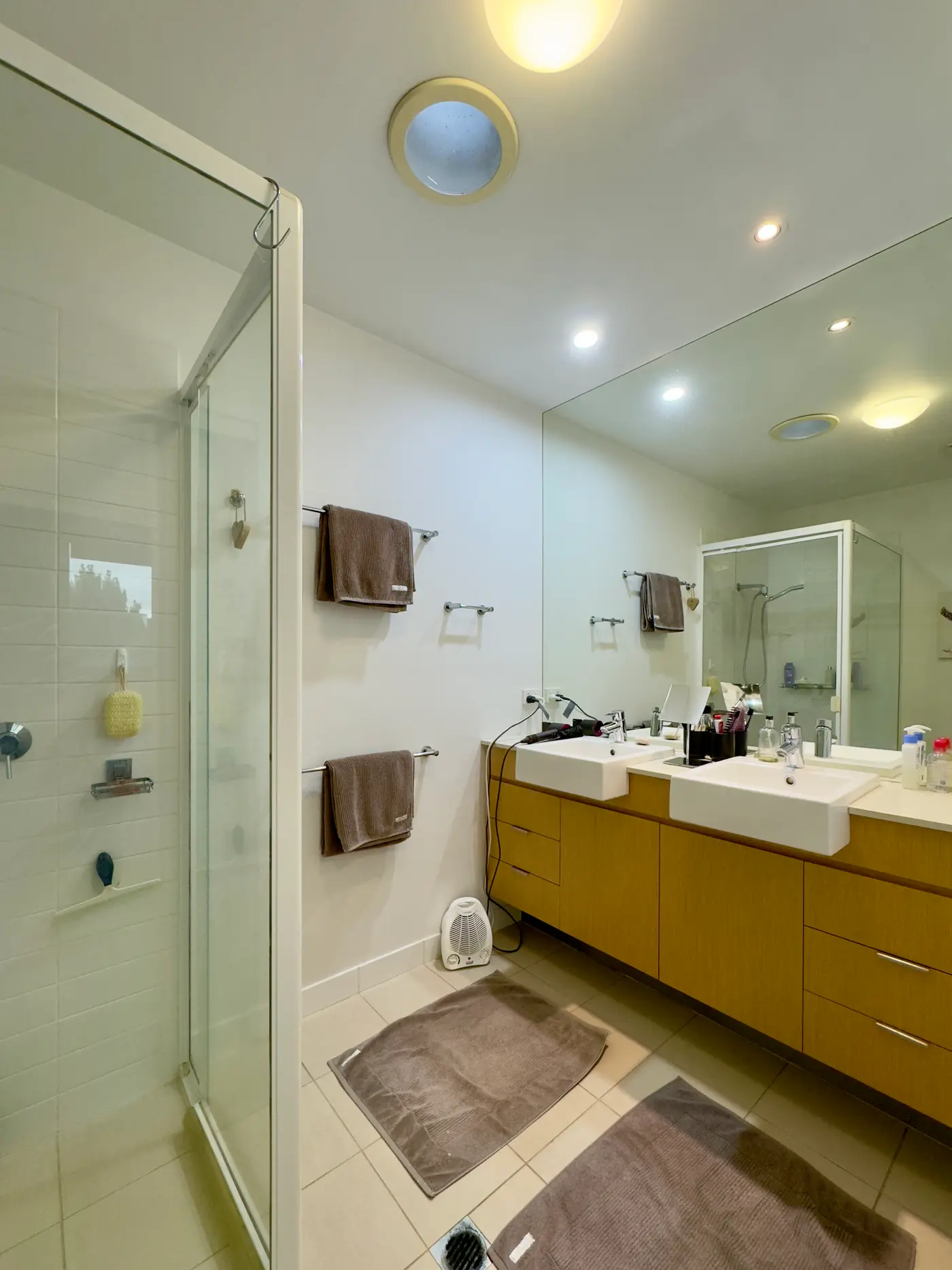 A bright bathroom with a white tub, a window, and a simple vanity.